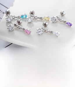 Detail of colorful teardrop zircon earrings with star studs in five dopamine colors