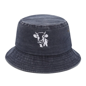 Faded grey denim bucket hat featuring a white cow head embroidery for outdoor sun protection