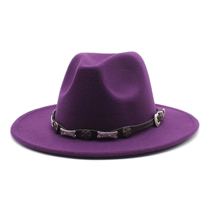 Close-up of dark purple felt fedora hat featuring a vintage leather band with metal stars