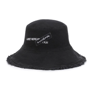 Black street style cotton bucket hat with distressed frayed edges and white embroidery