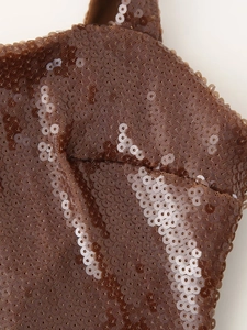 Macro shot of brown sequin fabric detailing the texture and shimmer of the evening dress