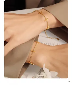 Detail of 18K gold-plated stainless steel bamboo link bracelet on a fashion background