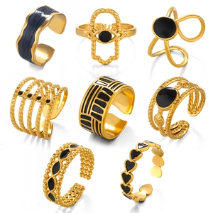 Set of 8 gold minimalist open rings with black enamel hearts and geometric designs