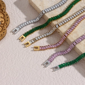 Detail of rectangular zircon bracelets in green, pink, and white with gold finish