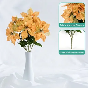 Golden silk poinsettia bouquet in a white textured vase for elegant Nordic home decor