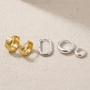 Solid water drop earrings in 18k gold, silver, and palladium finishes on brass