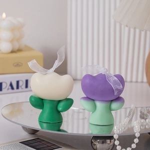 Detailed view of tulip scented candles in white and purple with elegant pearl accents