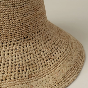 Close-up of premium raffia straw weaving and delicate floral embroidery texture