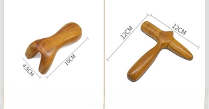 Detail view of Y-shaped and cross-shaped sandalwood massage tools with wood grain