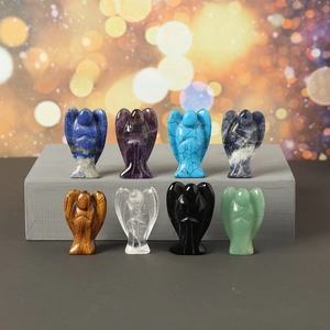 Macro detail of eight polished 1.5-inch crystal angel carvings in diverse gemstones