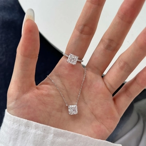 Close-up of S925 silver necklace and square-cut zircon ring set with pavé detailing