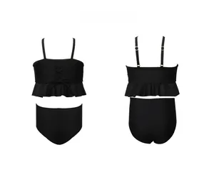 Detail of girls' black two-piece swimsuit with ruffled hem and adjustable straps