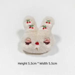 Detail of plush bunny accessory with cherry embroidery and 5.5cm size markings
