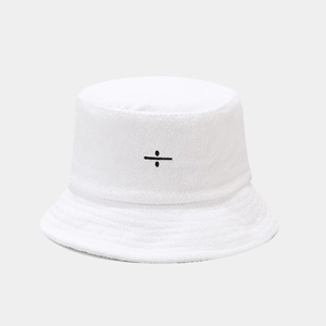 Close-up of a white towel-textured bucket hat featuring black division sign embroidery
