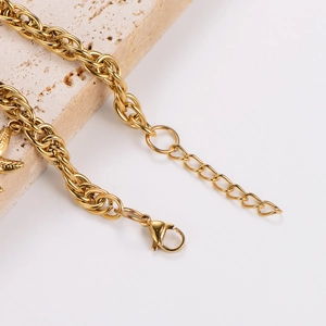 Close-up of gold stainless steel pearl bracelet with lobster clasp and extender chain