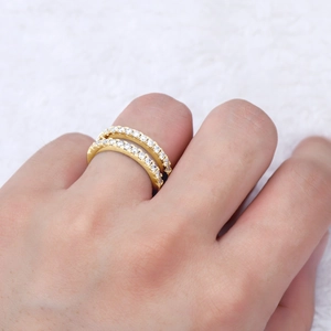 Close-up of double-row gold moissanite ring with micro-pave diamonds on model's finger