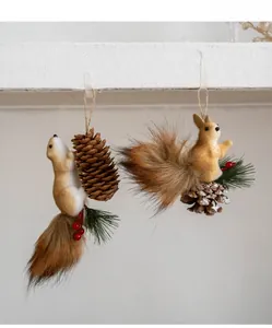 Close-up of squirrel ornaments with pine cones and faux fur for Christmas tree decor