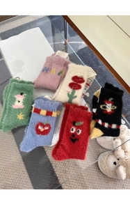 Flat lay of six pairs of fuzzy mink velvet mid-calf socks with cute cartoon fruit patterns
