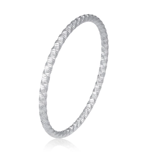 Macro view of minimalist silver stainless steel ring with twisted faceted texture