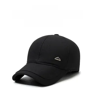 Detail of a black winter baseball cap with silver peak logo and warm ear protection