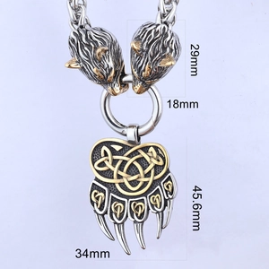 Detail of viking bear paw pendant with golden celtic knot and wolf head clasp connectors
