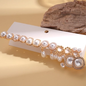 Detailed view of vintage pearl and rhinestone stud earring set on display card
