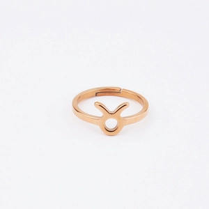 Detailed macro view of the rose gold Taurus zodiac symbol on a minimalist open ring