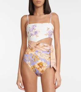 Detail of floral one-piece swimsuit featuring waist cutouts and stylish side tie-up straps