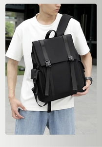 Side view of black nylon backpack with buckle closure on male model for daily commute
