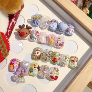 Detailed view of 3D Christmas nail art with reindeer, snowmen and festive pearls