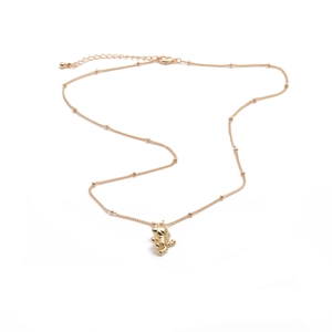 Gold-plated copper necklace with small ball chain and cute animal pendant on white background