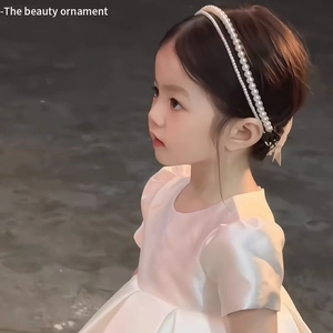 Elegant white double-row pearl headband for girls shown on a child model with a sweet style