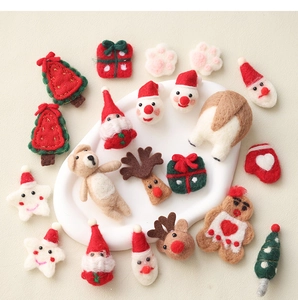 Close-up of handmade Christmas wool felt ornaments including Santa, elk and trees