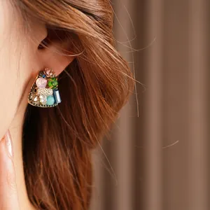 Vintage geometric earrings with multicolored rhinestones shown on model in studio