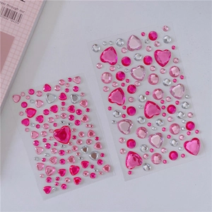 Macro detail of pink acrylic heart gemstones and 3D crystal stickers for DIY decor