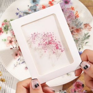 Detail of pink floral PET stickers on a white frame for creative journaling and DIY projects