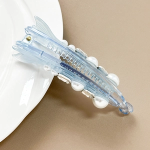 Detail of light blue crystal banana clip with white pearls and sparkling rhinestones