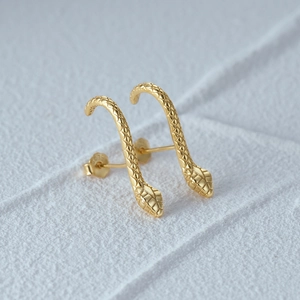 Macro shot of gold-plated S925 sterling silver snake earrings with detailed scale texture