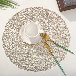 Elegant gold hollow PVC round placemat set with a white coffee cup and cutlery