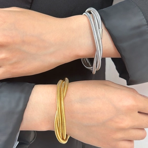 18K gold and silver multi-layer layered stack coil bracelet with textured spiral finish