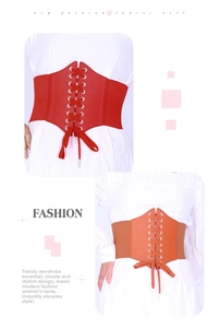 Close-up of vintage elastic corset belts in red and orange with lace-up metal eyelets