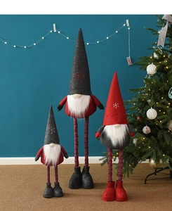 Three assorted Christmas gnomes with retractable legs in red and grey festive indoor setting