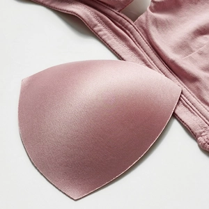 Detailed close-up of rose pink ribbed seamless wireless bra with high-quality stitching