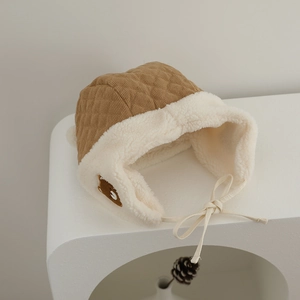 Detail of baby winter hat with plush faux shearling lining and cute bear patch