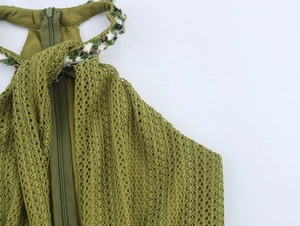 Close-up of green crochet dress back featuring mesh texture and invisible zipper detail