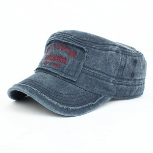 Detail of washed navy military cap featuring red survivor embroidery and frayed edges