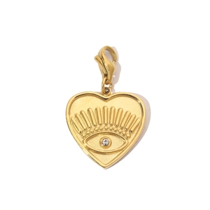 Macro view of gold heart pendant with eye engraving and rhinestone on lobster clasp