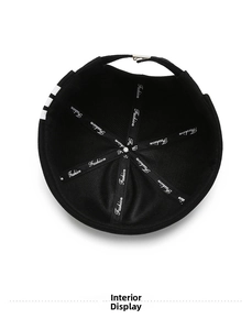 Detail view of the black knit beanie interior with reinforced Fashion logo tape and seams