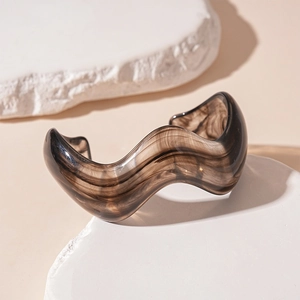 Modern amber acrylic irregular wave open bangle featuring a unique marble texture finish