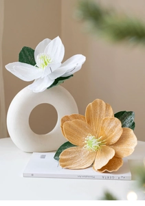 Detail of white and champagne artificial magnolia flowers with fine glitter on petals